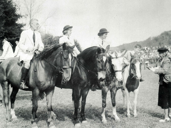 Bingham family receiving a blue ribbon in the family class at Tryon Horse Show